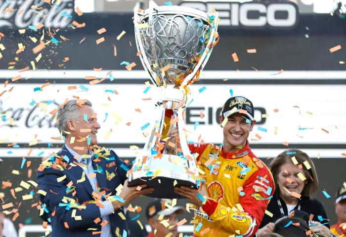 NASCAR President Steve Phelps presents the Bill France NASCAR Cup Series Championship trophy to Joey Logano in victory lane after Logano won the 2022 championship at Phoenix Raceway on Sunday. (Photo by Sean Gardner/Getty Images)